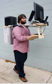 man-carrying-a-desktop-computer-around-his-shoulders-as-if-it-is-a-mobile-device.jpg